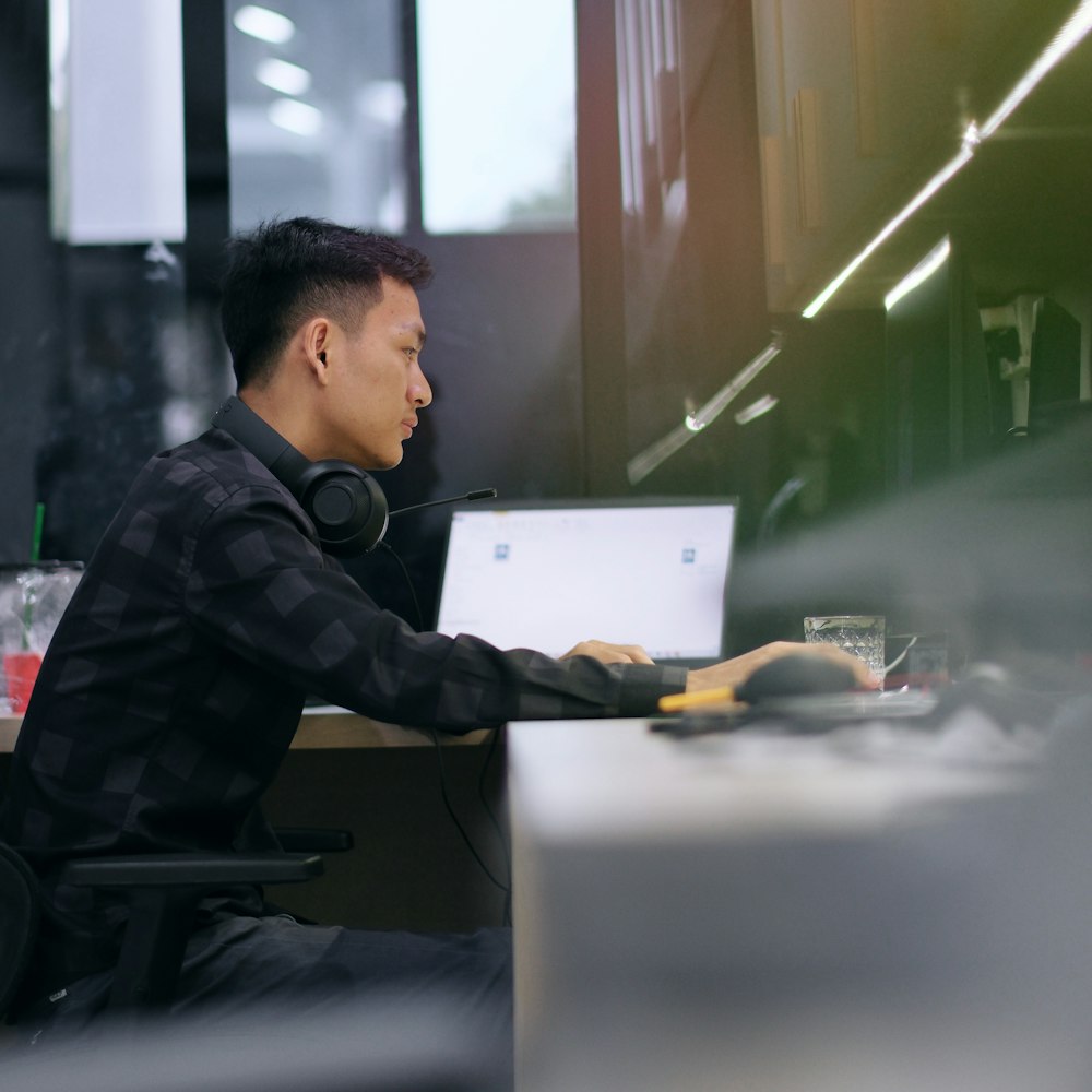 a man sitting in front of a laptop computer