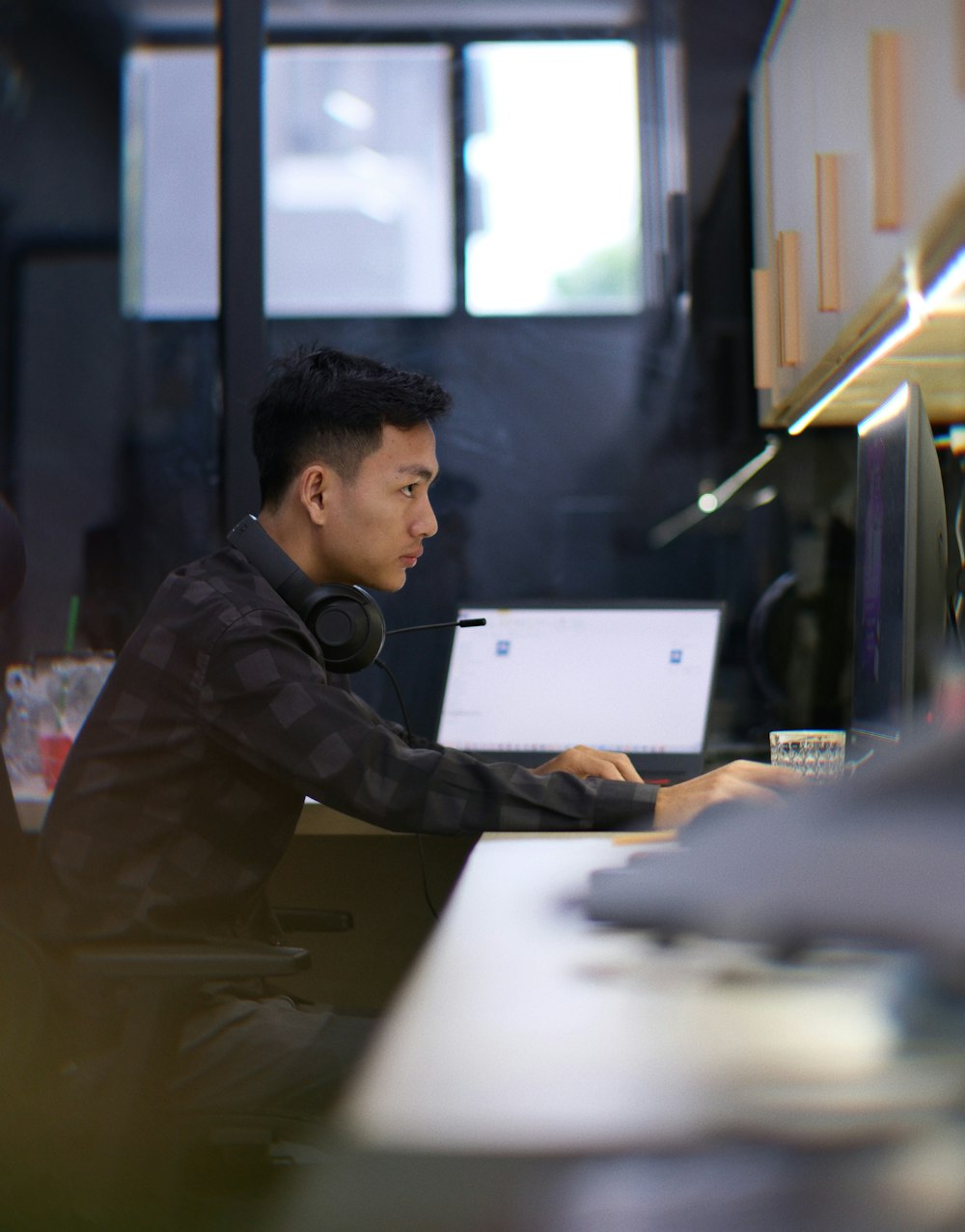 a man sitting in front of a laptop computer