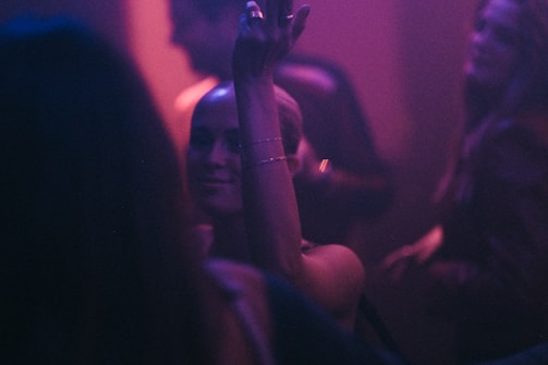 Vibrant dance floor moment with blurred motion of energetic guests under warm lights.