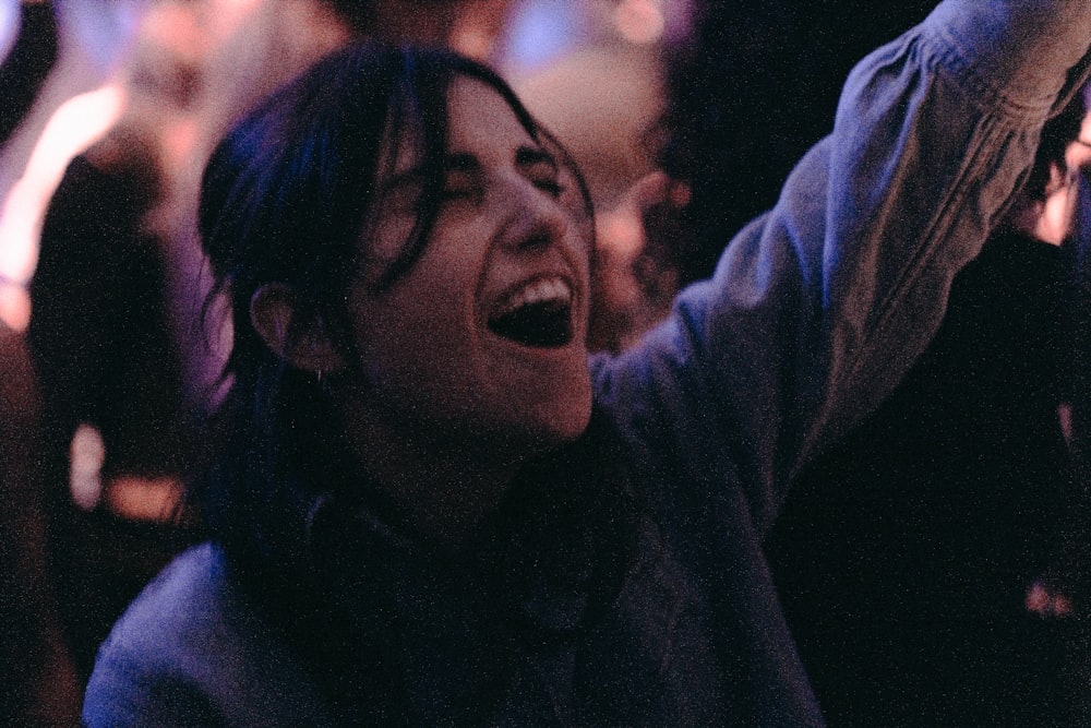 a man holding a cell phone up in the air