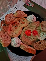 Close-up of a beautifully arranged plate featuring a variety of finger foods and dips.