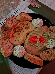 A tempting plate of smoky bacon dip served with crunchy vegetable sticks on a wooden table.