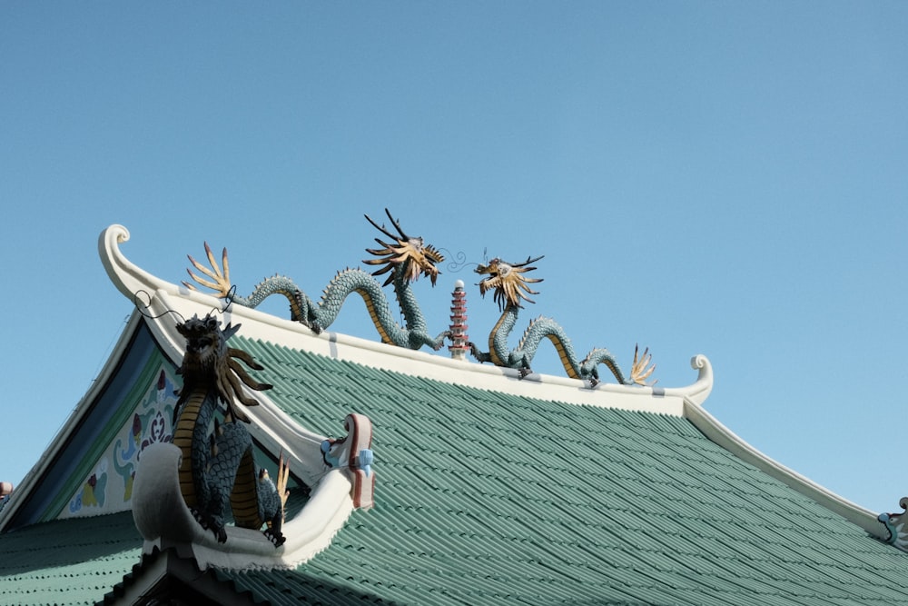 a statue of a dragon on top of a building
