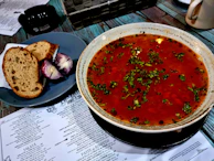 A steaming plate of traditional Hungarian goulash served with rustic bread.