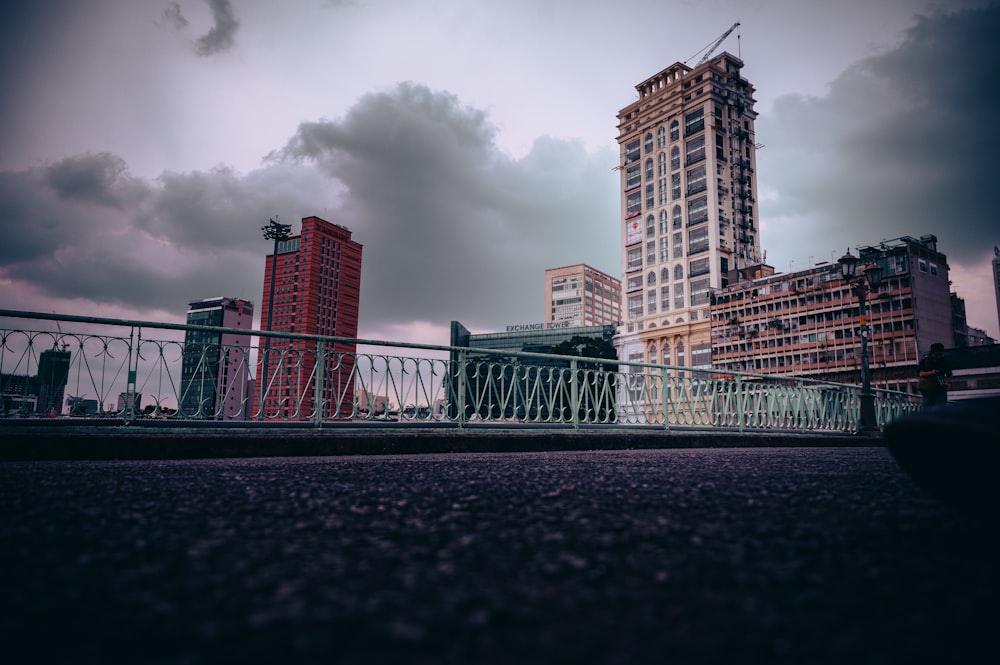 a city skyline with tall buildings and a bridge