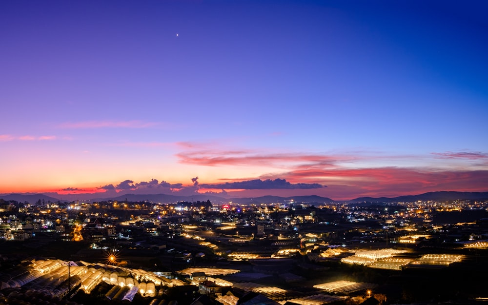 a view of a city at night from a hill