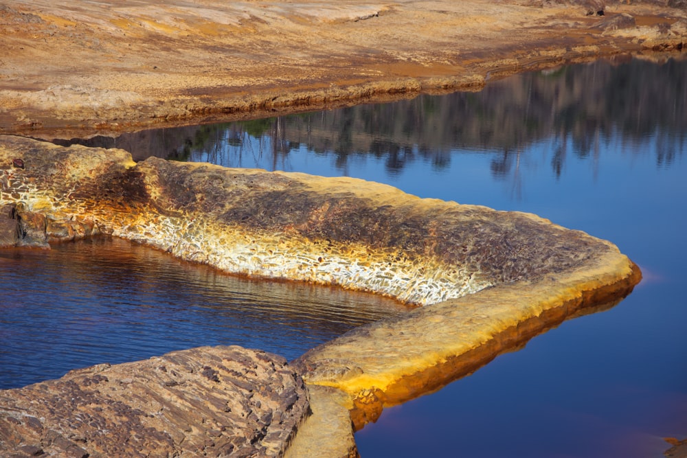 a body of water surrounded by large rocks