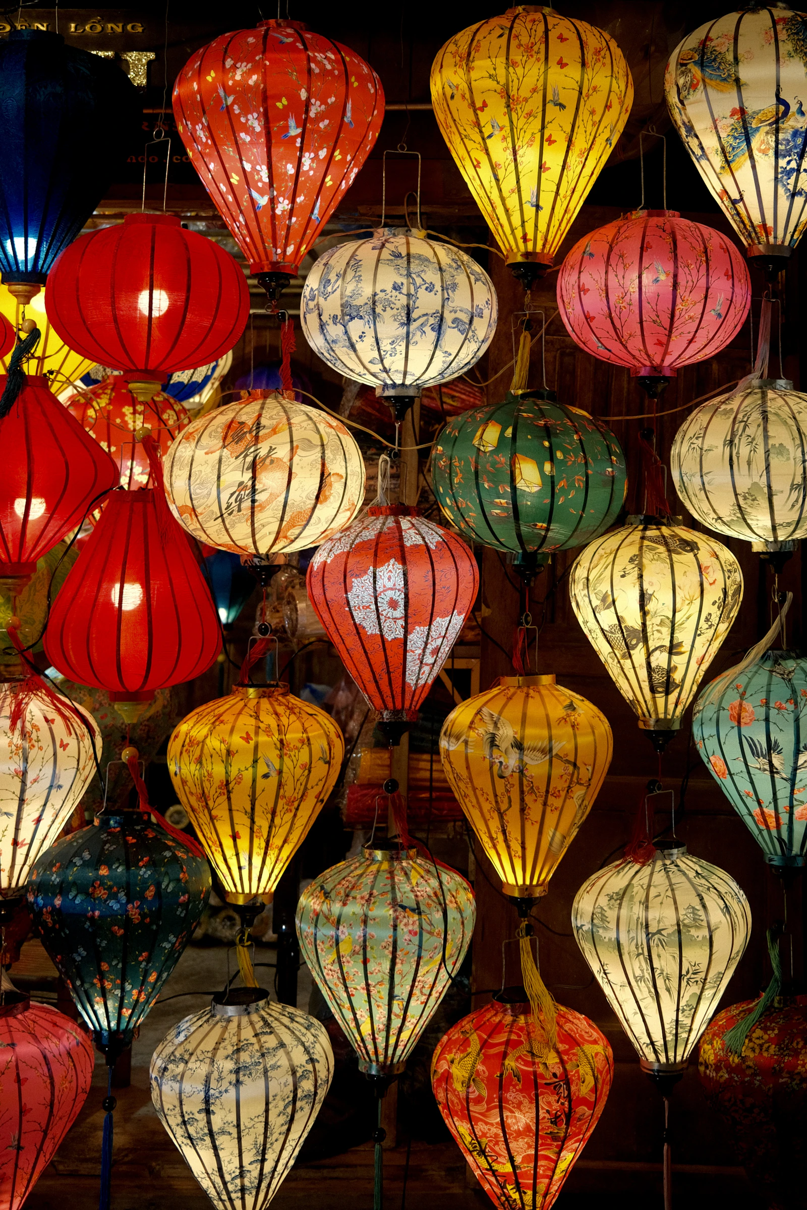 Colourful handmade lanterns glowing in Hoi An
