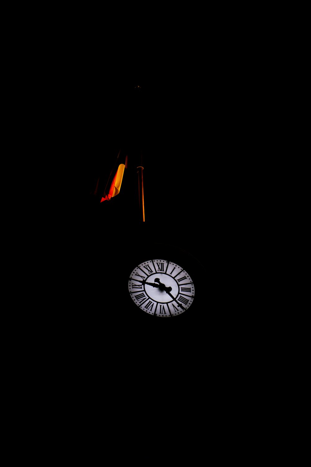 a clock is lit up in the dark