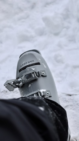 A cozy winter boot placed on a snowy background, showcasing its warmth and design.