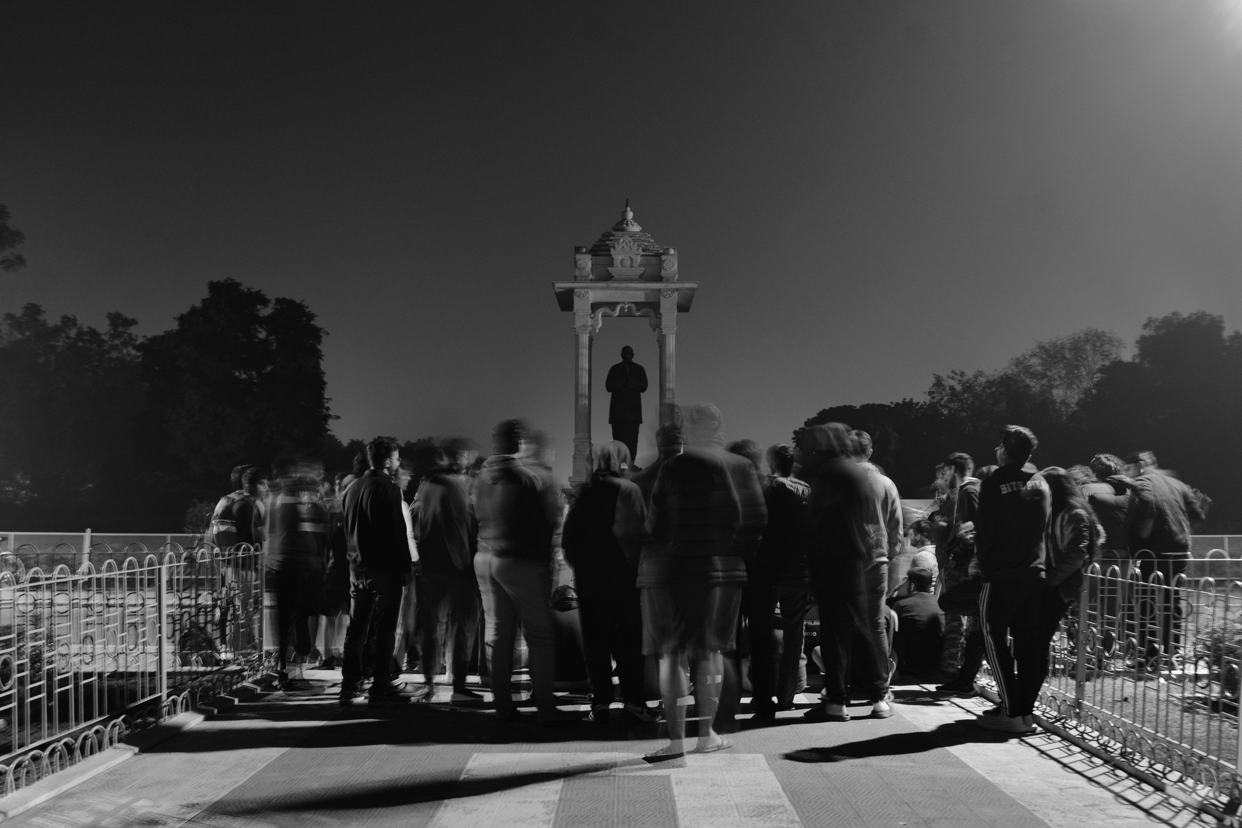 Student gathering at campus statue