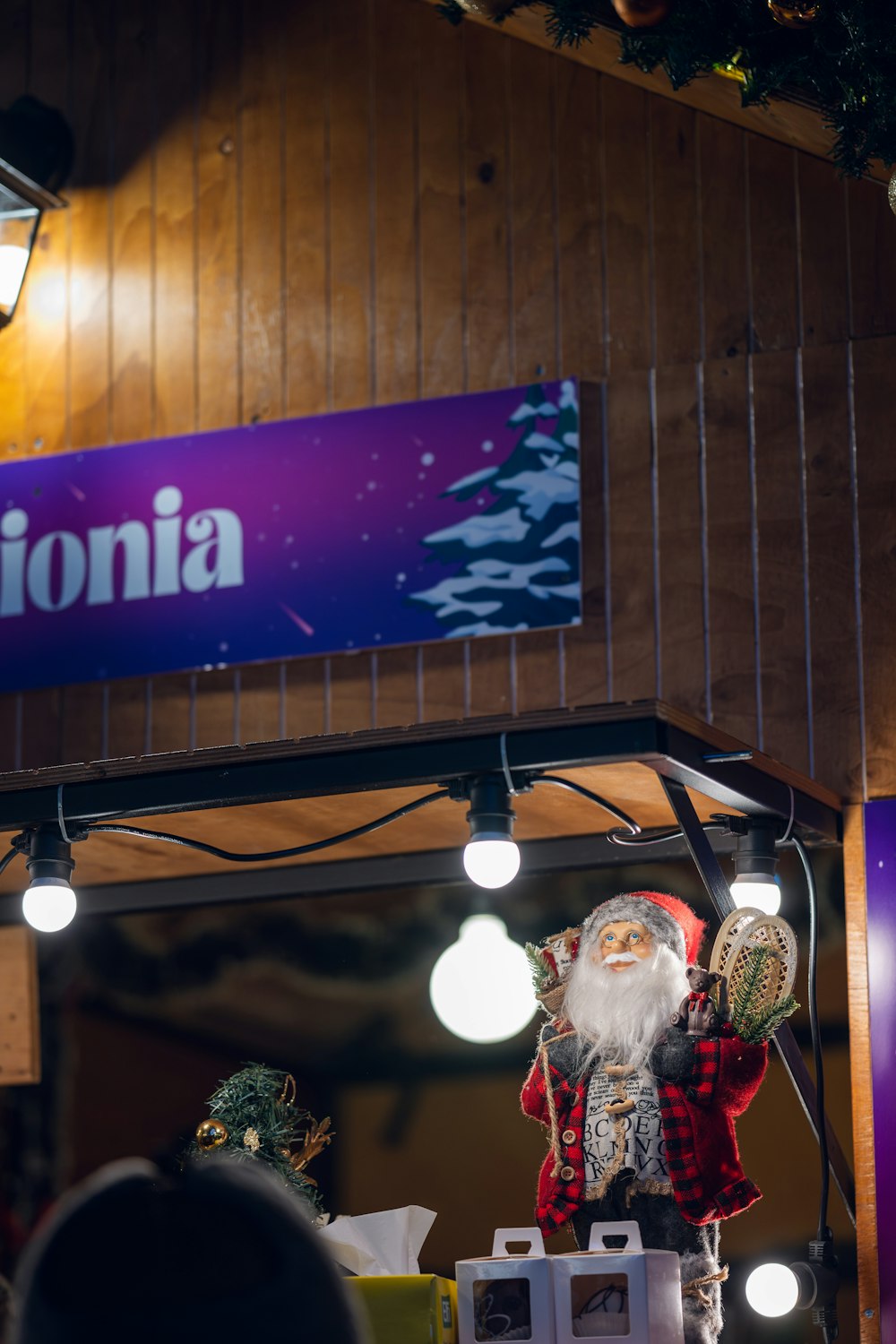 a statue of santa claus in front of a california sign