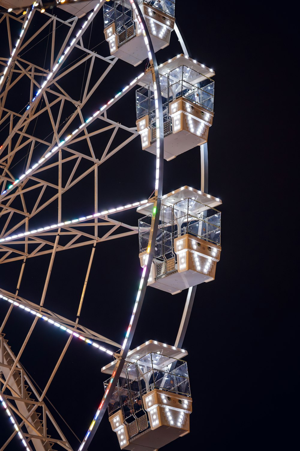 a ferris wheel lit up at night with lights