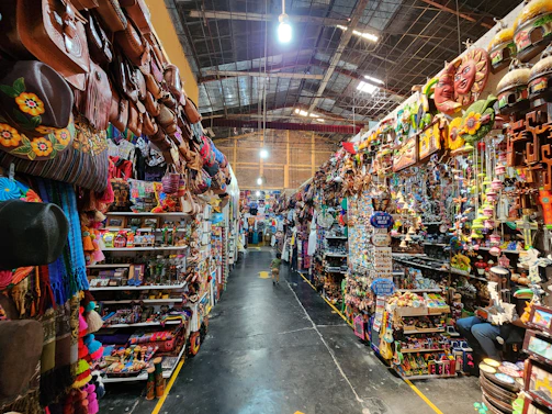 A vibrant display of colorful shopping bags overflowing with diverse products from around the world.