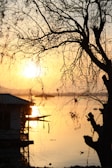 the sun is setting over a body of water