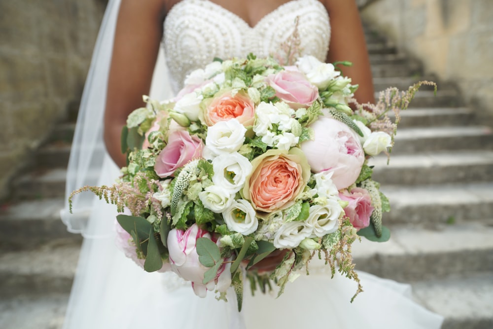 a bride holding a bouquet of flowers on her wedding day