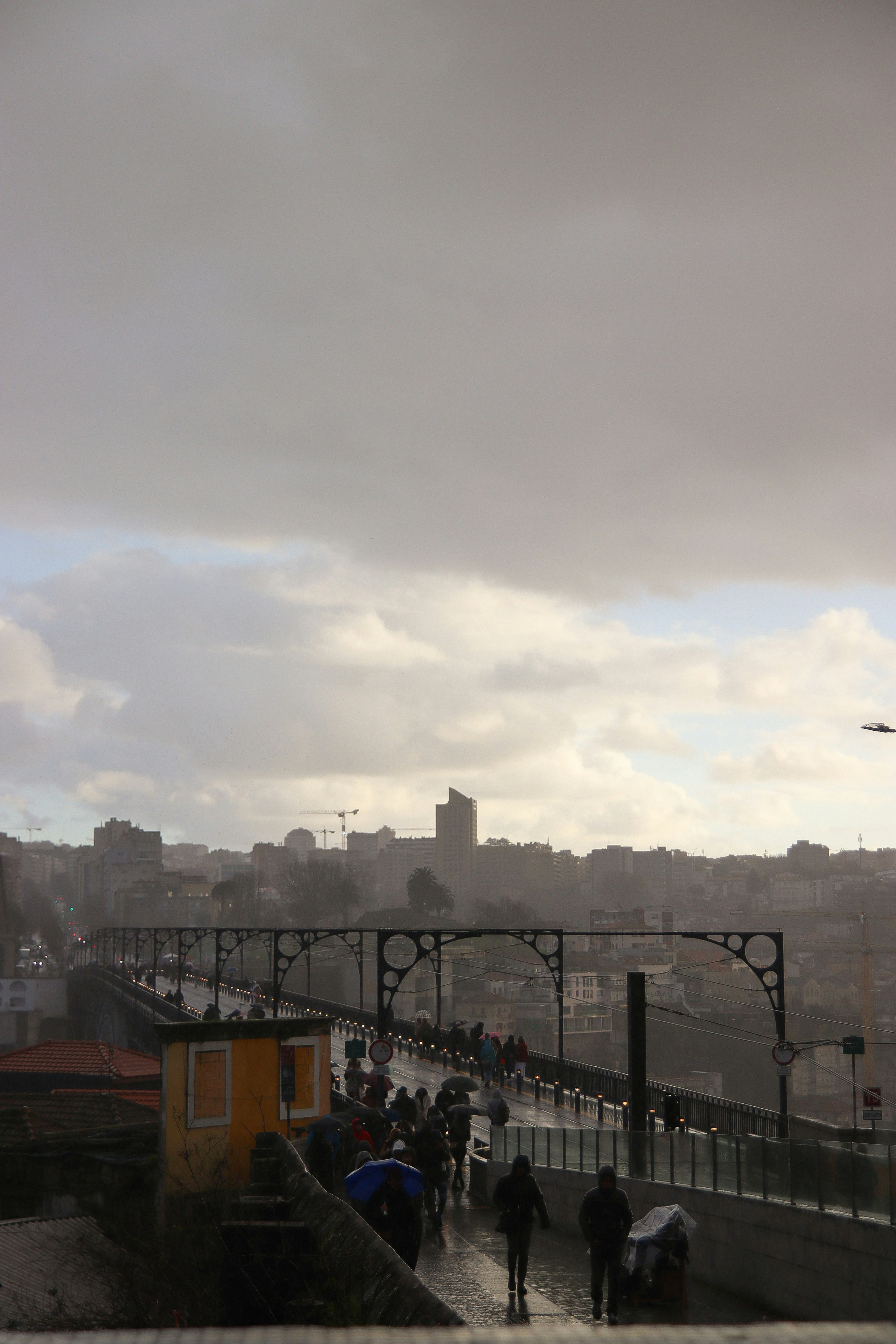a group of people walking across a bridge