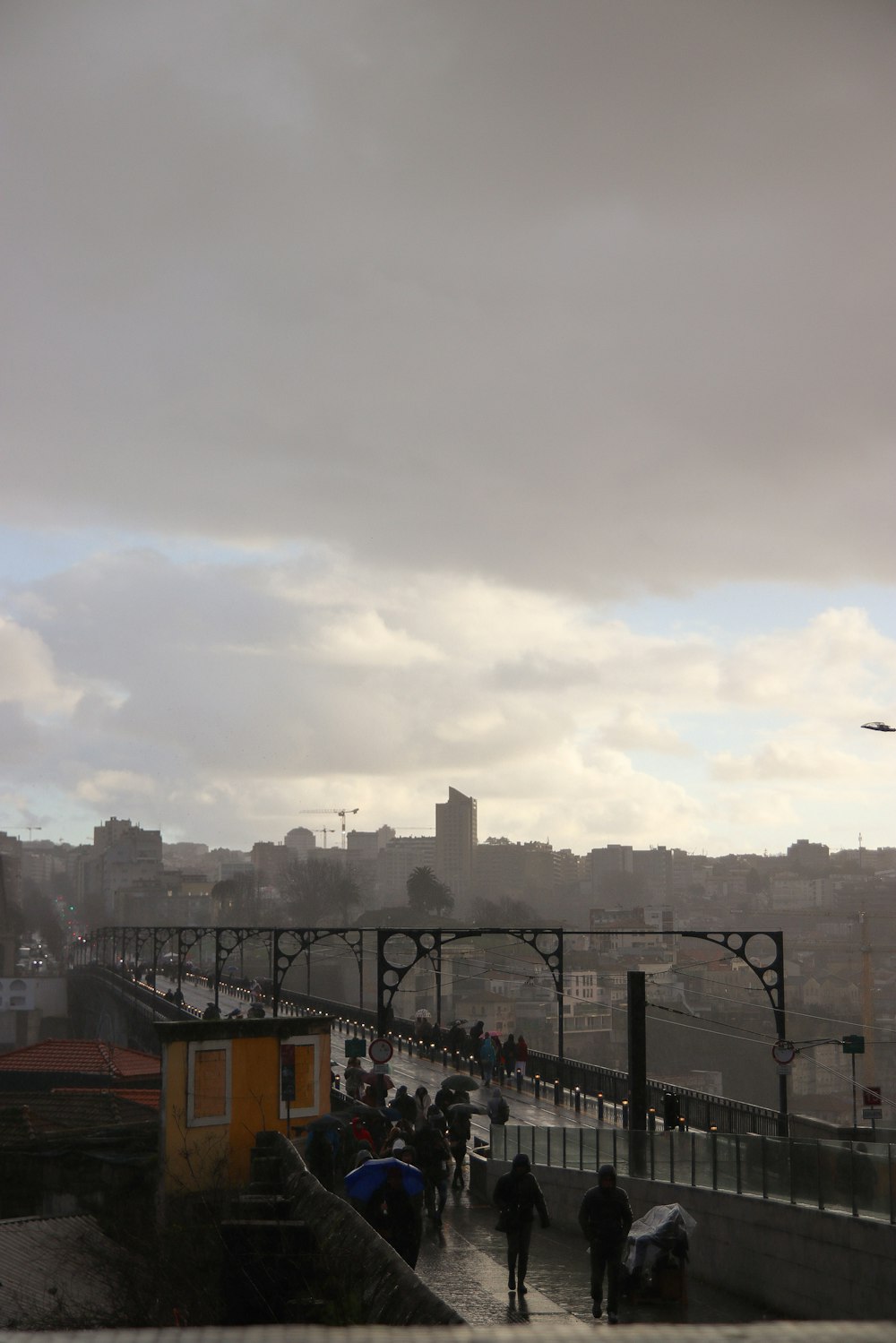 a group of people walking across a bridge