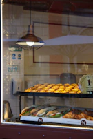 A cozy corner of the bakery showcasing an assortment of pastries and sweets under warm lighting.