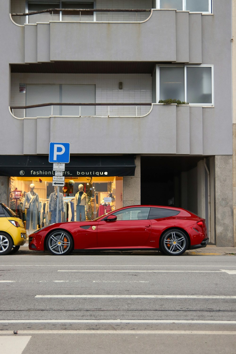 a red sports car parked next to a yellow sports car