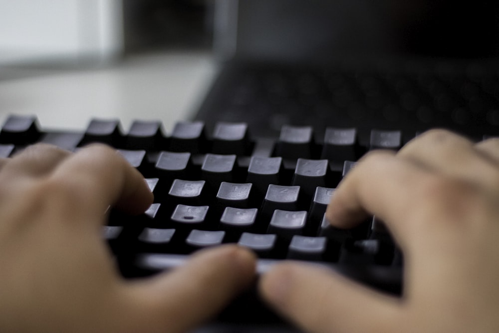 a person typing on a computer keyboard