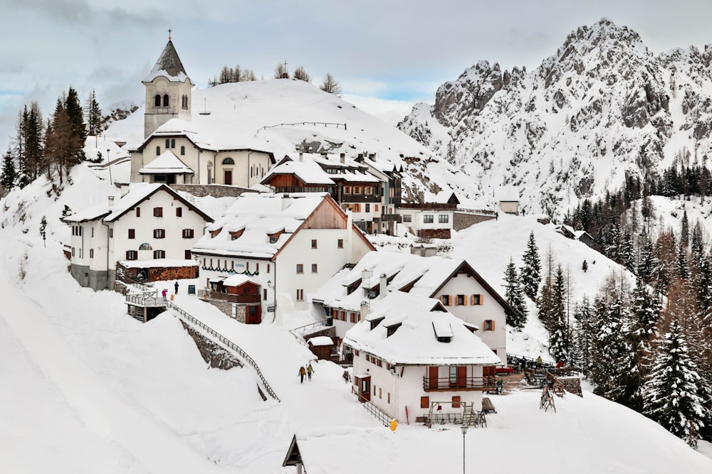 a snow covered mountain with a village on top of it