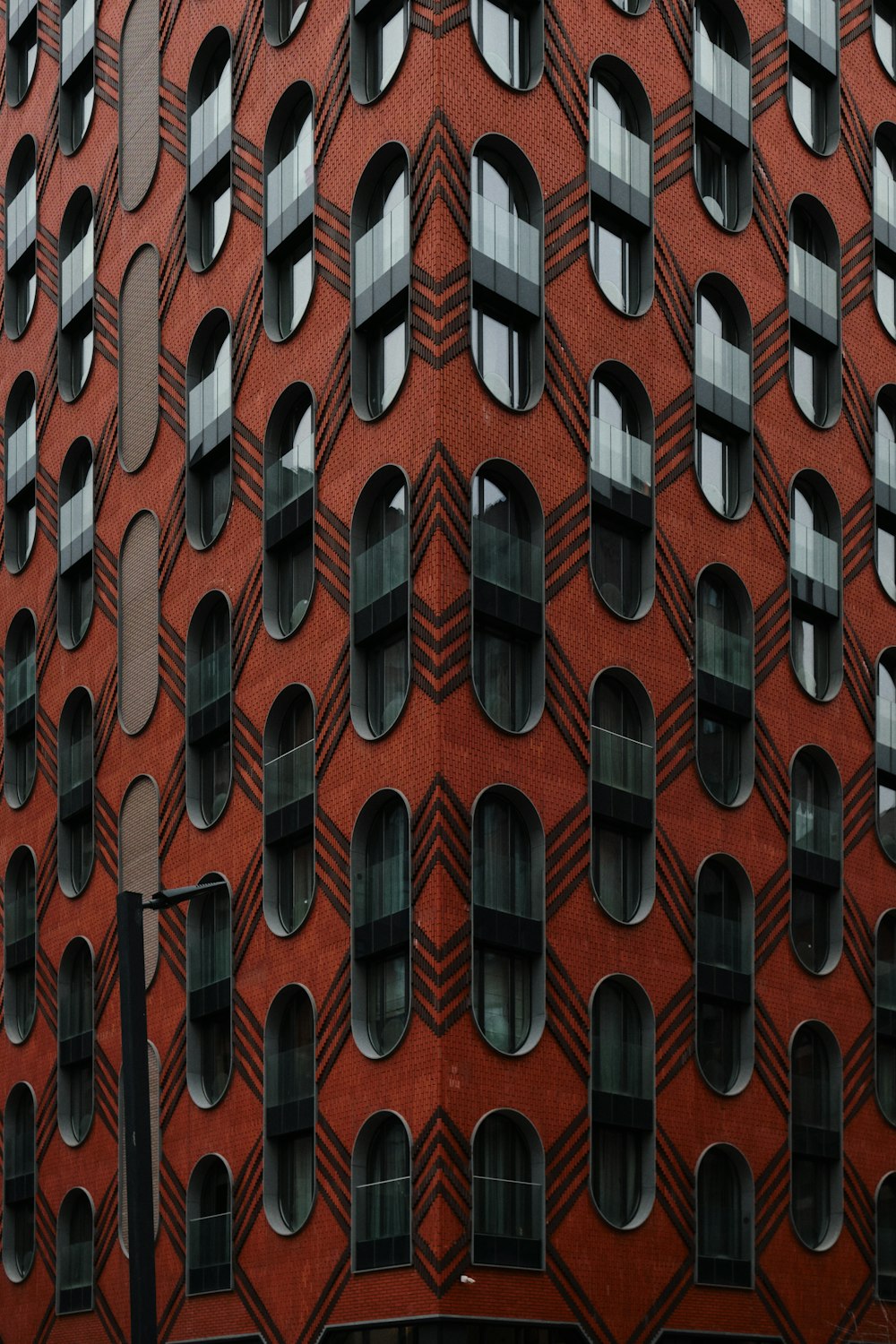 a red building with lots of windows and a clock