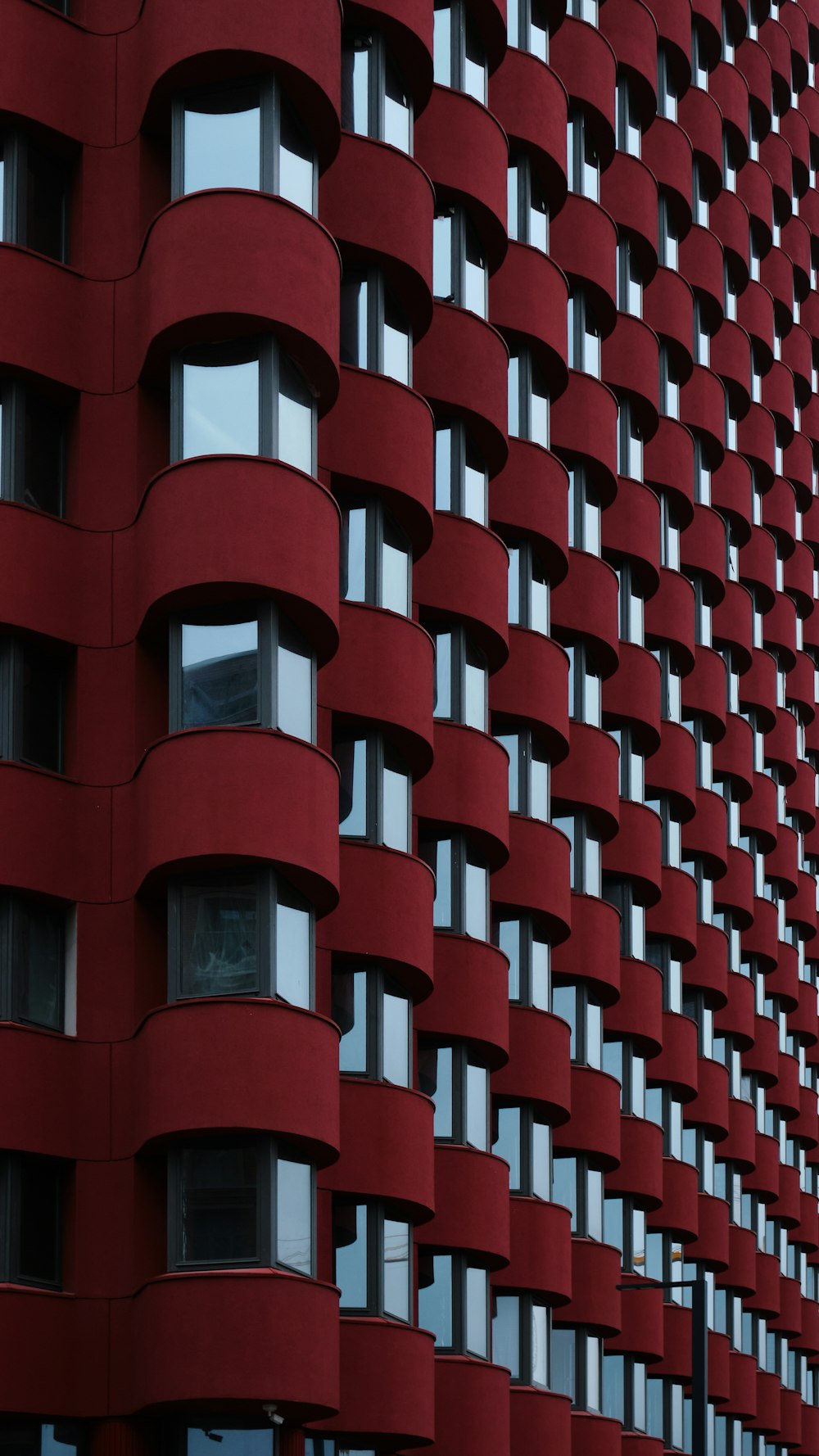 a very tall red building with lots of windows