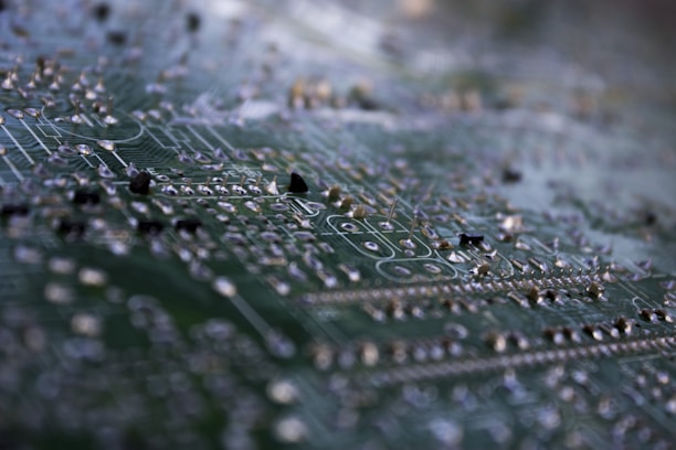 Close-up macro shot of a sleek multi-layer PCB with glowing electric blue traces.