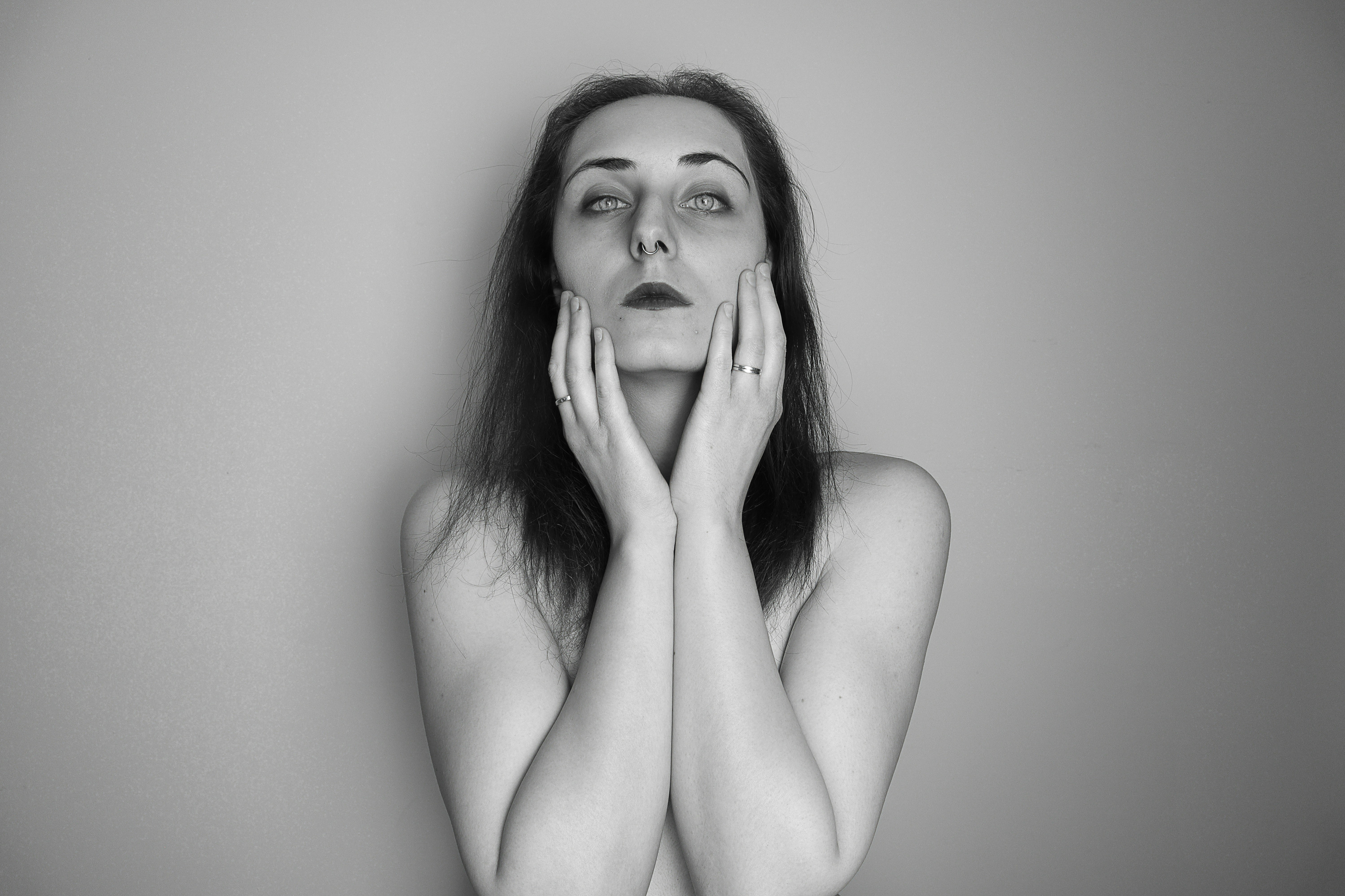 Black and white photo of a woman with her hands on her face