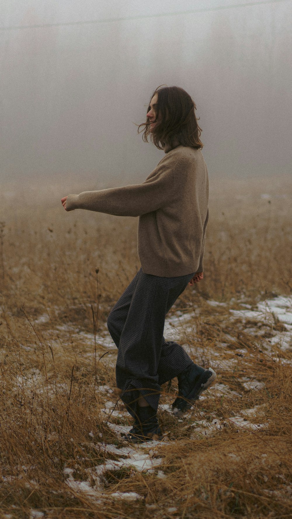 a person standing in a field with a frisbee