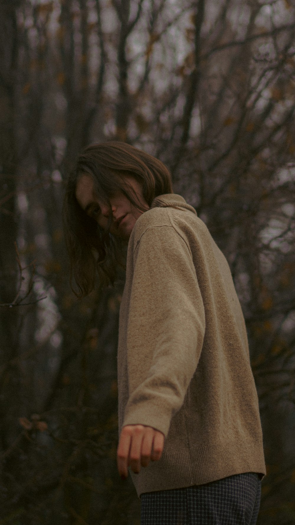 a person standing in front of some trees