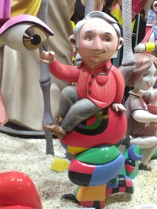 Olita sitting on a colorful art installation with curious eyes