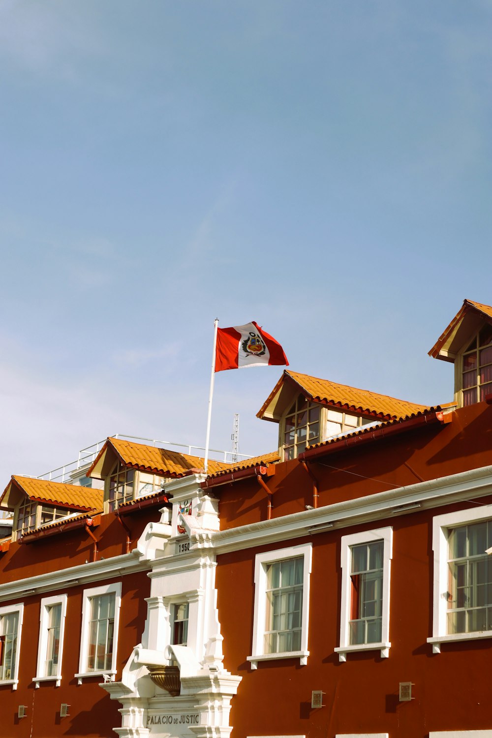 a red building with a flag on top of it