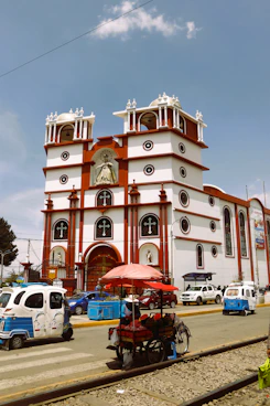 a large white and red building with a clock on it's side