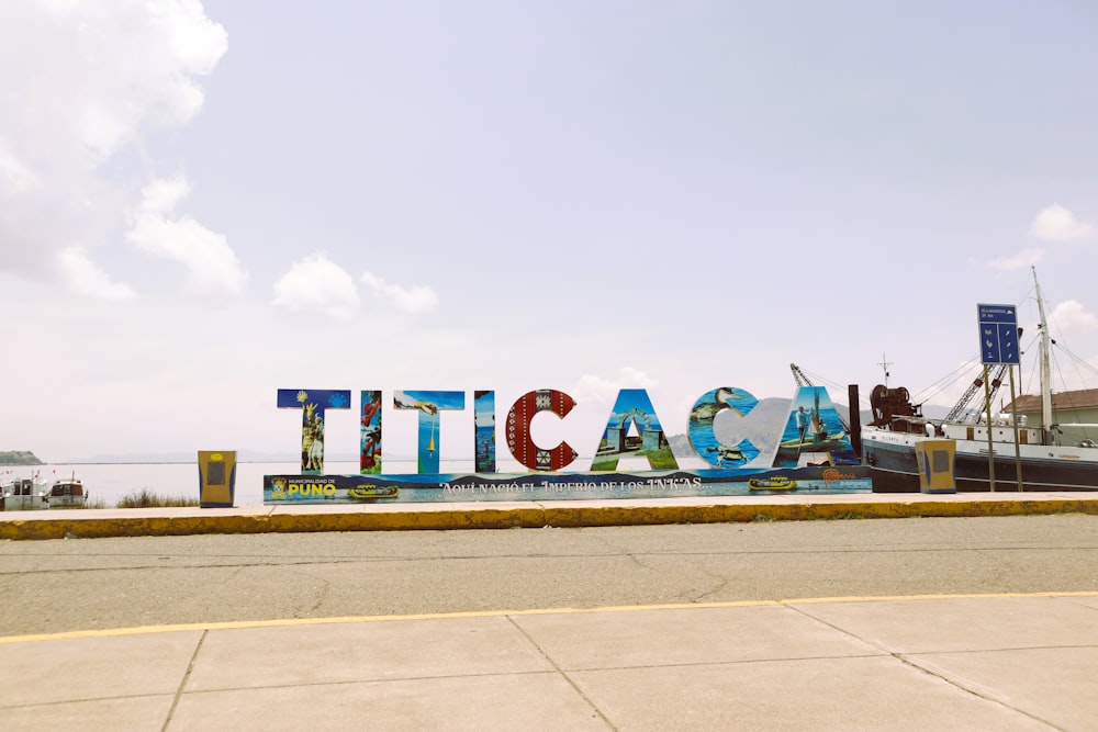 a large sign that says tica on the side of a road