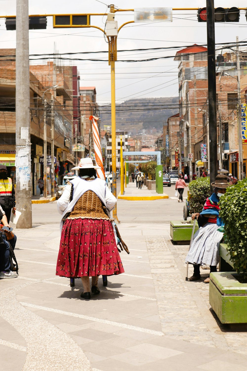 a woman walking down a street with a basket on her back