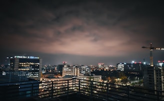 A nighttime cityscape showing infrastructure projects illuminated, symbolizing ongoing development and progress.