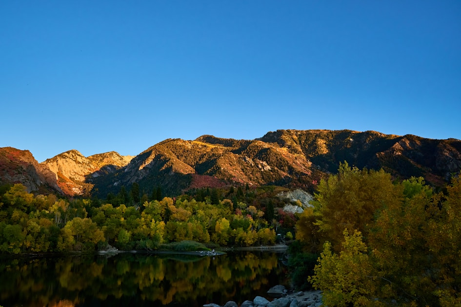 Lake surrounded by mountains with trees in foreground, Utah Book Cliffs elk country
