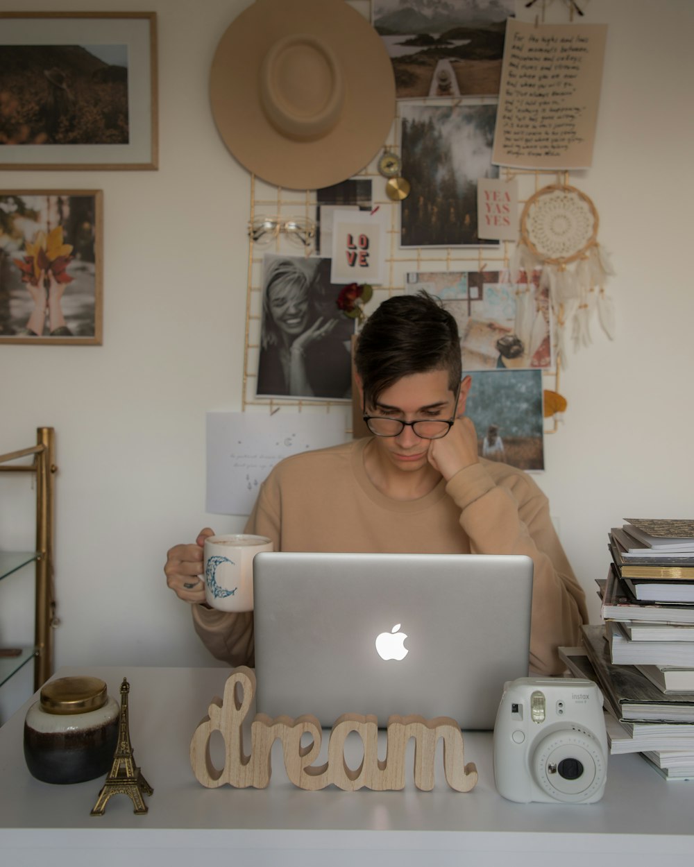 a woman sitting in front of a laptop computer