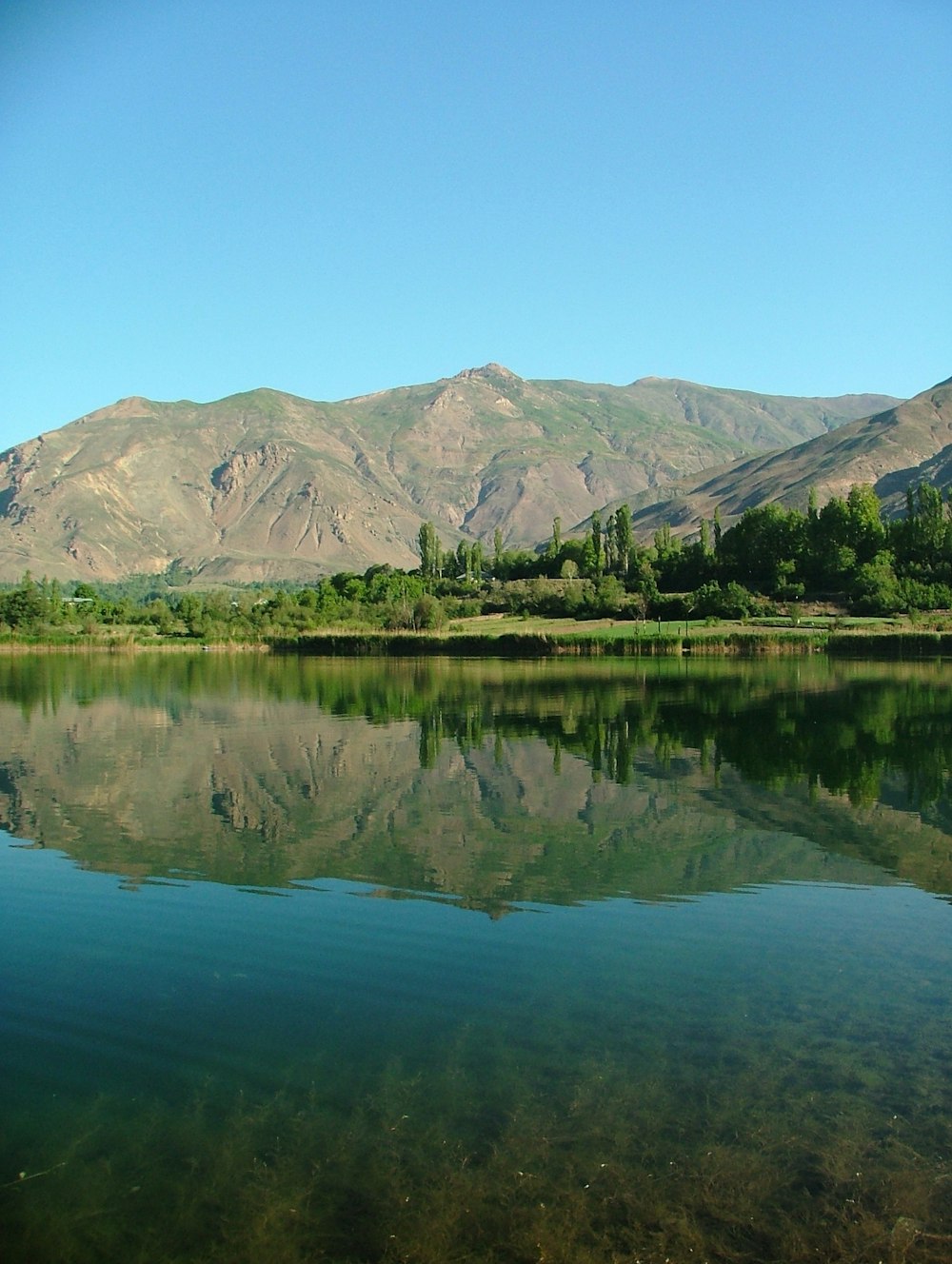 a large body of water with mountains in the background