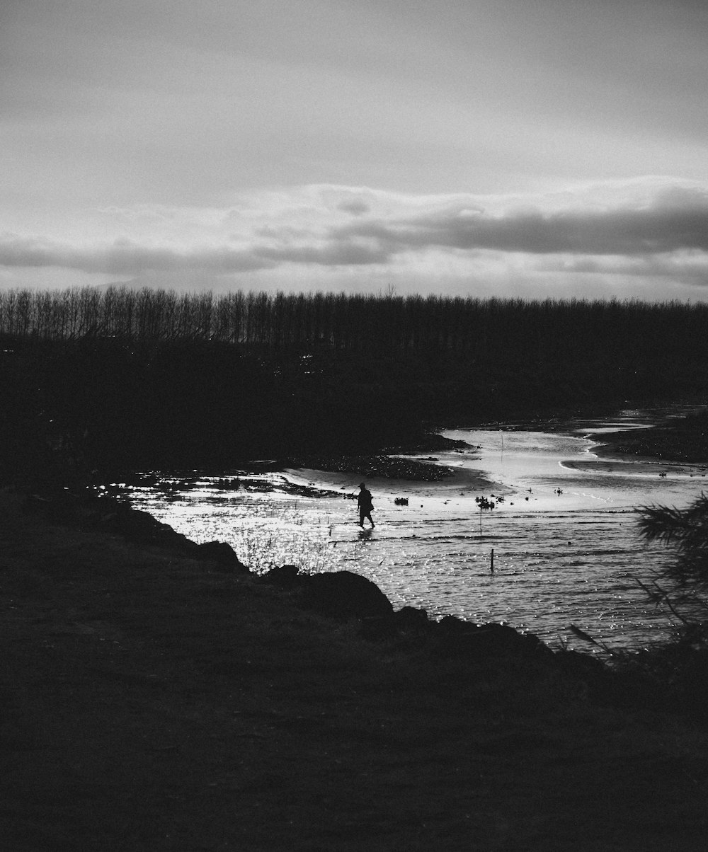 a black and white photo of a person on a surfboard