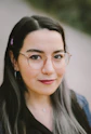 a woman wearing glasses and a black shirt
