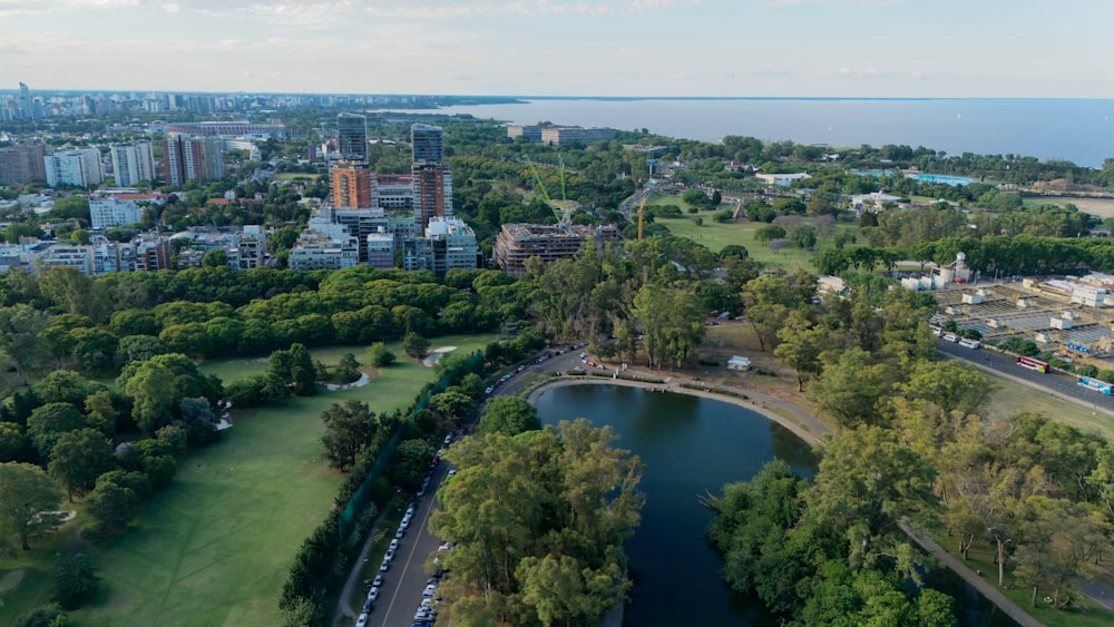 an aerial view of a city with a lake in the foreground