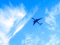 An airplane captured mid-flight against a clear blue sky.