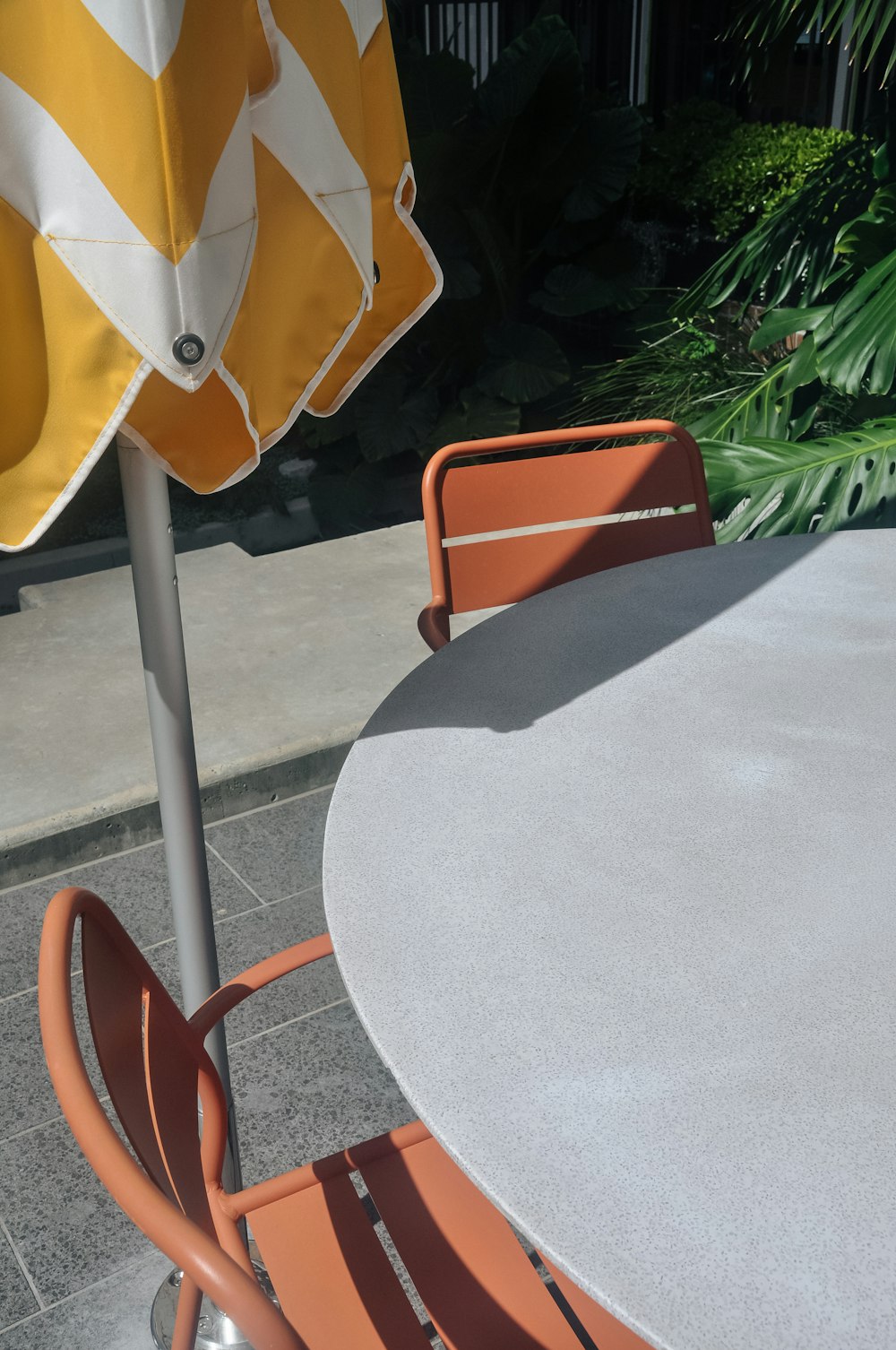 a table with two chairs and an umbrella