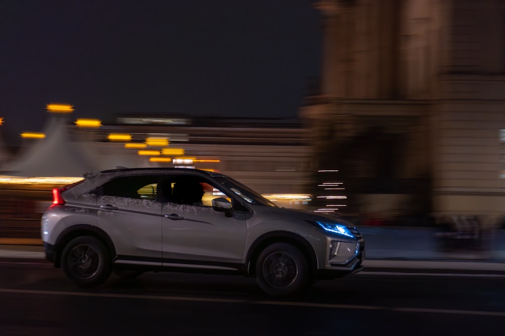 a car driving down a city street at night