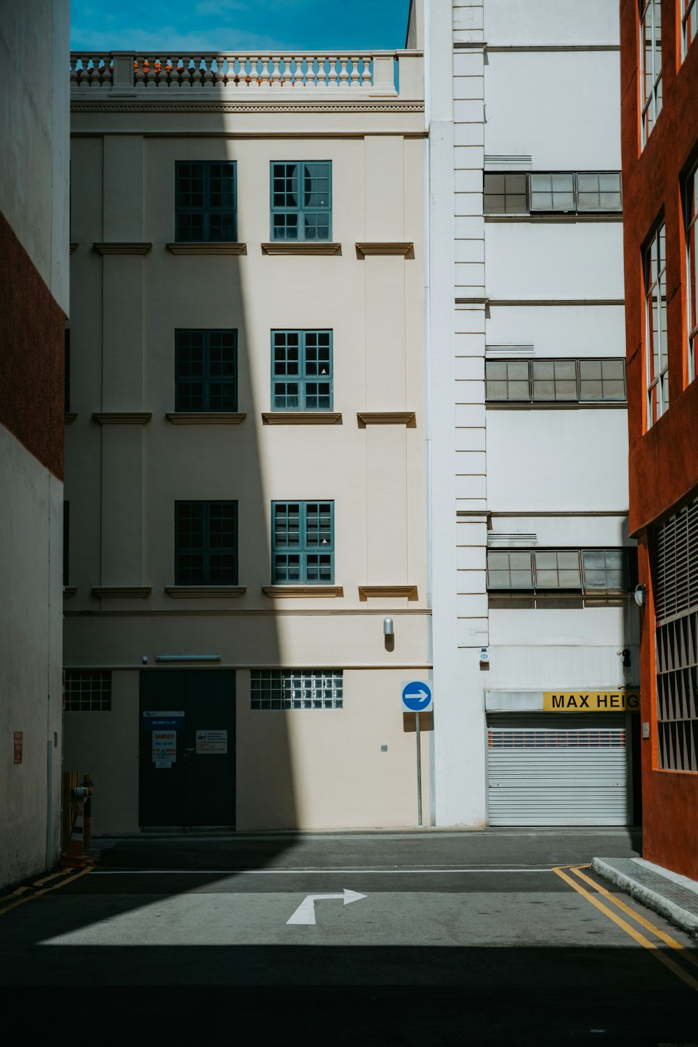 an empty street with a building in the background