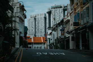 Contemporary shophouses (ruko) with glass facades and elegant design in urban Jakarta area.