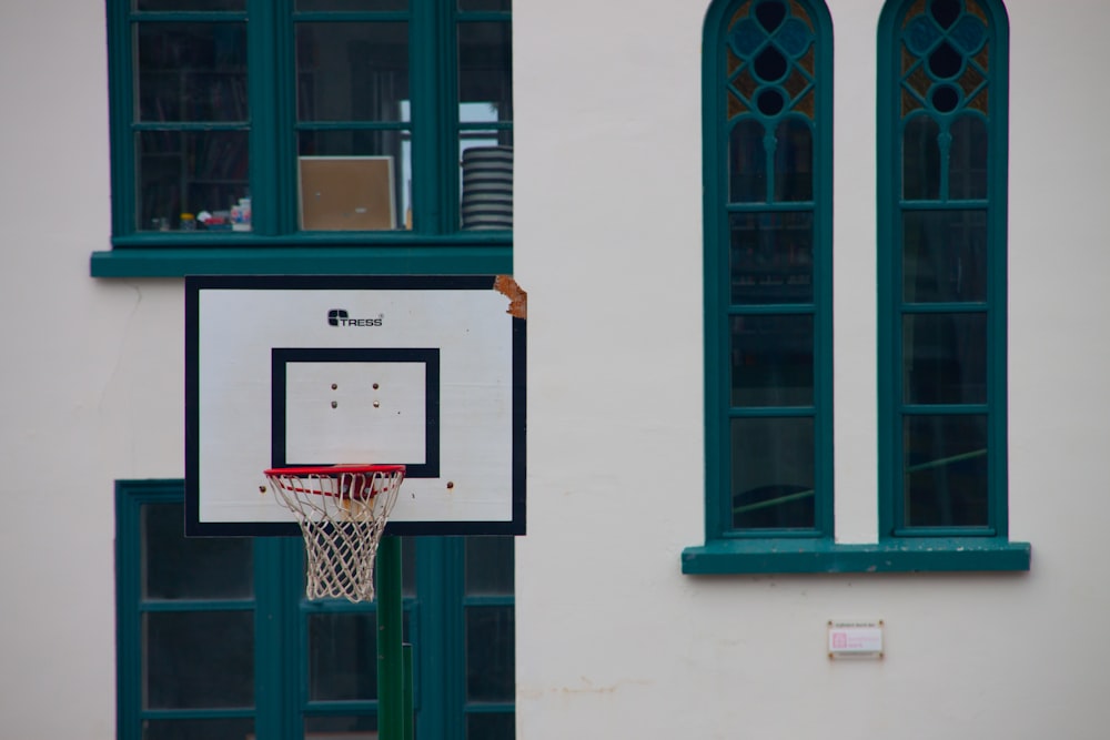 a basketball hoop in front of a white building